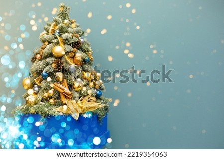 Beautiful Christmas tree decorated in lights on a blue background.