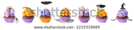 Set of tasty Halloween cupcakes on white background