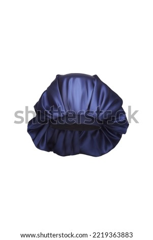 Close-up shot of a dark blue sleep cap with a wide elastic band. A satin hair bonnet for protecting hair at night is isolated on a white background. Front view. Royalty-Free Stock Photo #2219363883