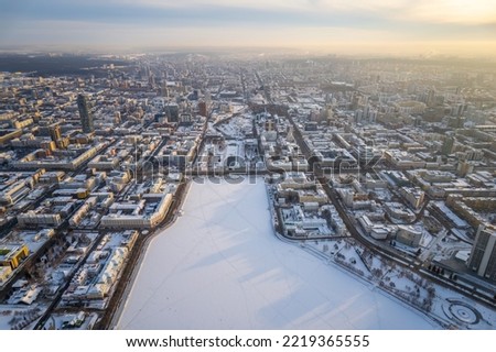 Embankment of central pond and Plotinka in Yekaterinburg at winter sunset. Winter snow-covered city. The historic center of the Yekaterinburg, Russia, Aerial View
