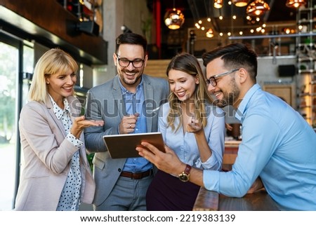 Multiracial business people, friends having fun, working and laughing drinking coffee in coffeehouse