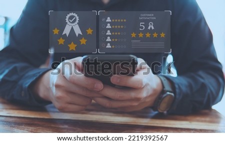 Customer review good rating concept and hand pressing smile face icon and five star on visual screen for quality and positive customer feedback, testimonial and testimony.