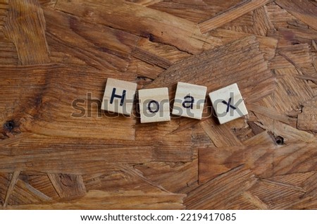 Hoax text on wooden square, business quotes Royalty-Free Stock Photo #2219417085