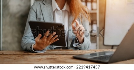 Woman using on smartphone and tablet at office as concept