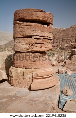 Petra, Jordan, November 2019 - A close up of a stone building that has a large rock