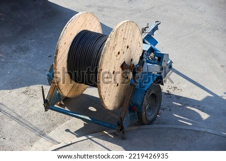 Concept of electricity supply for construction projects. Wooden coil with power cable.