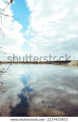 Beautiful evening landscape with clouds reflected in the lake water.