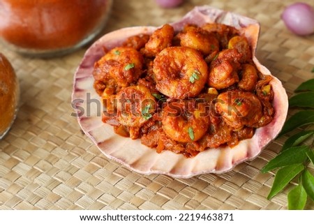 Spicy hot Prawn roast or shrimp fry. Masala fish curry served in sea shell. Indian food Asian cuisine. Kerala fish curry also popular in South Indian Bengal Goa. Royalty-Free Stock Photo #2219463871