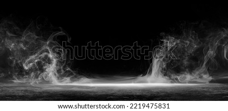 Abstract image of dark room concrete floor. Black room or stage background for product placement.Panoramic view of the abstract fog. White cloudiness, mist or smog moves on black background.  Royalty-Free Stock Photo #2219475831
