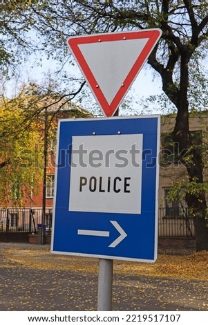 Yield and police traffic sign on the street