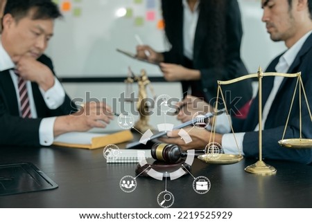 Lawyers discuss agreements with clients or staff at the office.