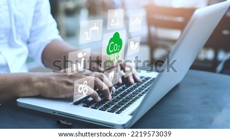 Person using laptop for working technology and business Net zero and carbon neutral concept. Renewable energy-based green businesses can limit climate change and global warming. Reduce CO2 emission