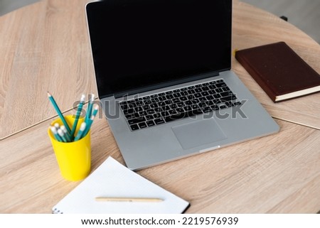Workplace with laptop, notepad and pencils at home