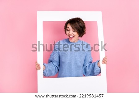 Photo of funky positive person hold paper album card look empty space isolated on pink color background