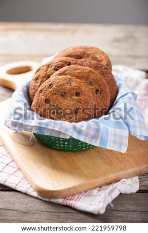 Fresh chocolate chip cookies setting on wood table