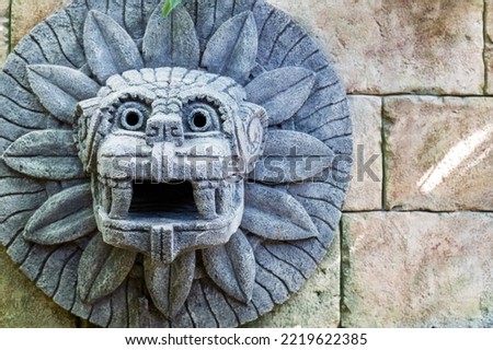 animal head made of stone on the wall in the style of South American Indians. imitation of history