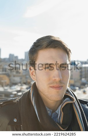 Portrait of confident man against cityscape