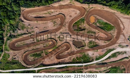 Sport. Motorsport, motocross. Dirt track for motocross, top view from a drone. Summer cloudy day.
