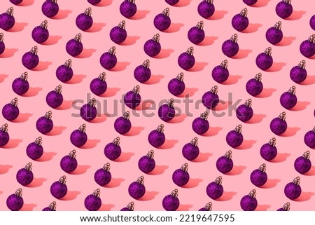 christmas ball purple pattern on light pink background. High quality photo