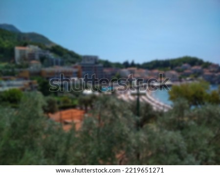 blurred photo Panoramic view of the city with houses in the mountains and the beach. Budva. Montenegro. September 2019