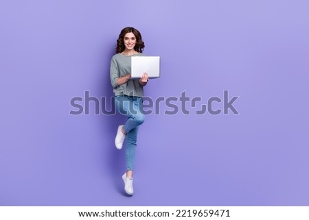 Full length photo of adorable nice lady wear trendy clothes rejoice new quality purchase empty space isolated on purple color background