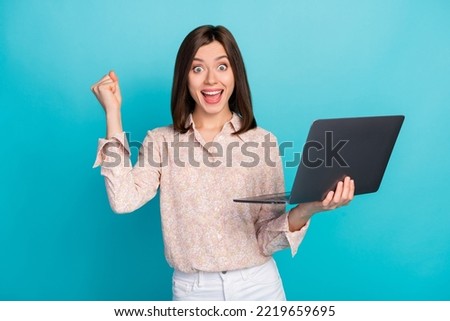 Photo of charming attractive pretty business lady hold her netbook crazy celebrate her company win tender excited isolated on bright blue color background