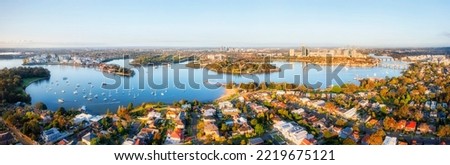 Western  Sydney in wide aerial panoram along Parramatta river from Inner city to Ryde and Parramatta suburbs. Royalty-Free Stock Photo #2219675121