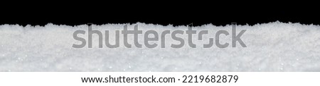 Banner of sparkling fluffy white snow isolated on black Royalty-Free Stock Photo #2219682879