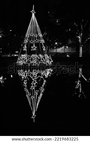 The magic of Christmas events and the culture of decorating homes and cities at Christmas represented in a black and white photograph