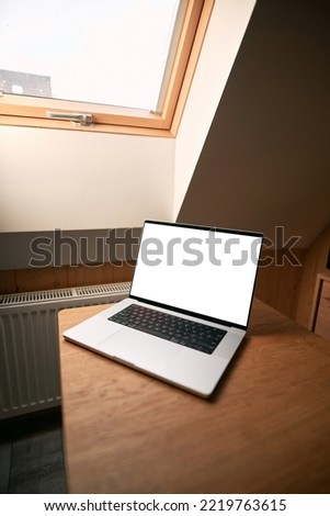 Modern portable computer mock-up. Blank screen for website or application placing. Isolated laptop indoors without people.