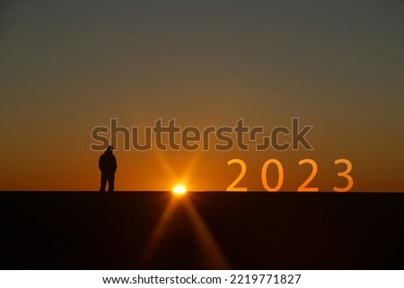 Silhouette of New year 2023 letters on the rooftop with sunset light, Concept new success , goal , target start 2023 Mockup  