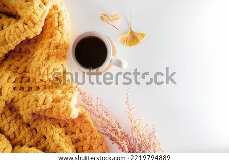 autumn composition on a white background. Cup of tea. dry leaves and yellow blanket. top view, flat lay, copy space