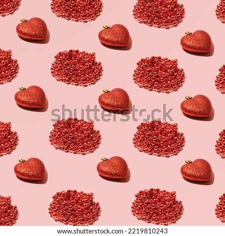 Christmas decorations, heart shape, creative pattern against candy pink background. 
