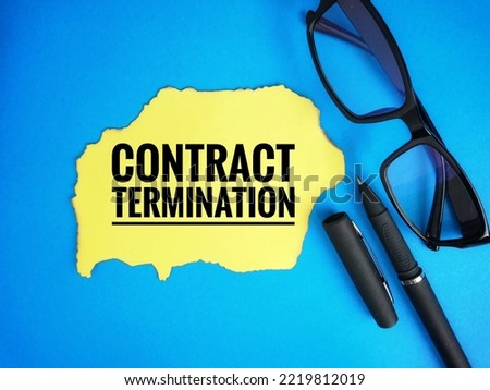 Text written Contract Termination at torn yellow paper, pen and spectacle on blue background.  Royalty-Free Stock Photo #2219812019