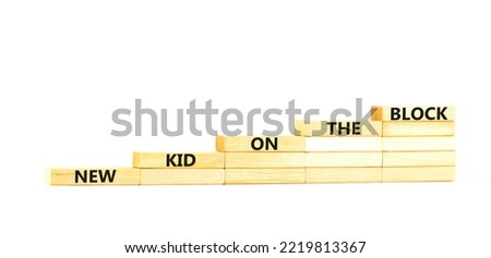 New kid on the block symbol. Concept words New kid on the block on wooden blocks. Beautiful white table white background. Business and new kid on the block concept. Copy space.