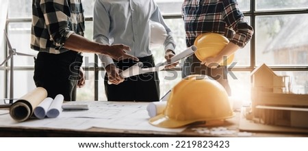 Civil engineer teams meeting working together wear worker helmets hardhat on construction site in modern city. Foreman industry project manager engineer teamwork. Asian industry professional team Royalty-Free Stock Photo #2219823423