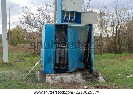War in Ukraine. 2022 Russian invasion of Ukraine. Countryside. An electrical transformer damaged by shelling. Destruction of infrastructure. Terror of the civilian population. War crimes Royalty-Free Stock Photo #2219826599