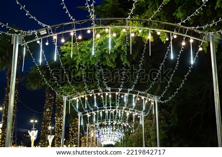 Colorful garlands, lanterns hang against the background of the night sky