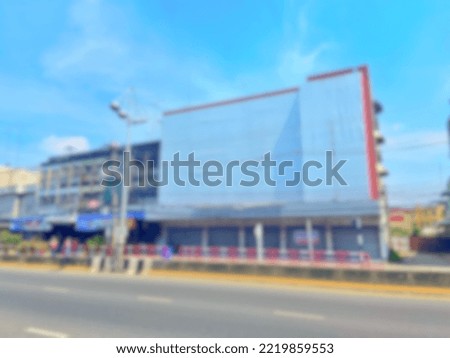 landscape photo blur image concept White building next to a street with lampposts.  The sky is clear and cloudy during the day.
