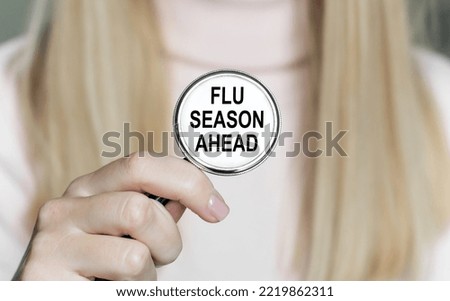 holding a stethoscope with text Flu Season, medical concept