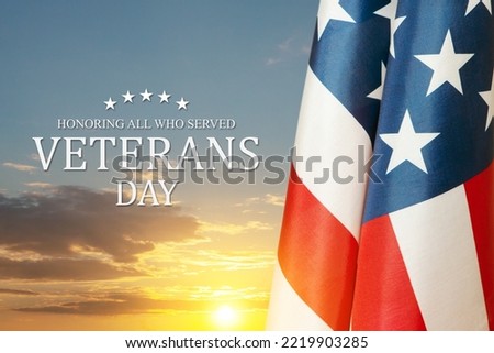 American flags with Text Veterans Day Honoring All Who Served on sunset background. American holiday banner.