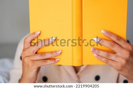 Hands holding a book - Focusing a yellow book