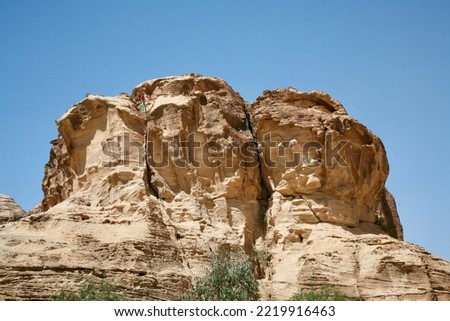Petra, Jordan, November 2019 - A tall rocky mountains on a rock