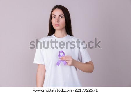Woman holding a purple ribbon in her hands ADD,ADHD,Alzheimer Disease ,Arnold Chiari Malformation,Childhood Hemiplegia stroke, Epilepsy, Chronic Acute Pain,Crohns Royalty-Free Stock Photo #2219922571