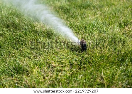 winterizing a irrigation sprinkler system by blowing pressurized air through to clear out water Royalty-Free Stock Photo #2219929207