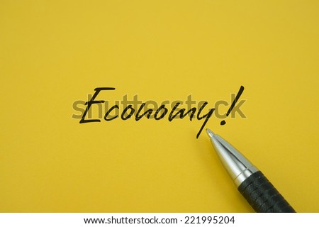 Economy! note with pen on yellow background