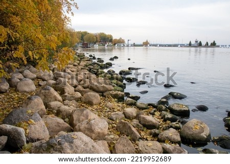 Large stones on the shore of the lake in autumn close up
