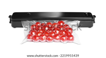 Sealer for vacuum packing with plastic bag of cherry tomatoes on white background Royalty-Free Stock Photo #2219955439