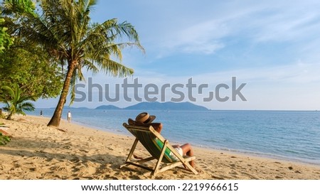 Asian Thai women watching the sunset on a beach chair at Klong Kloi Beach Koh Chang Thailand.  Royalty-Free Stock Photo #2219966615