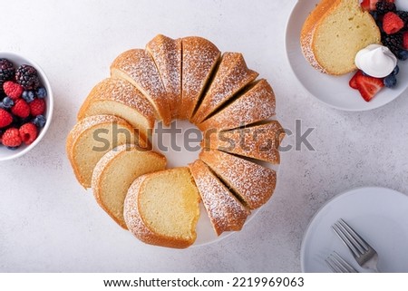 Pound cake baked in a bundt pan, traditional vanilla or sour cream flavor, dusted with powdered sugar Royalty-Free Stock Photo #2219969063